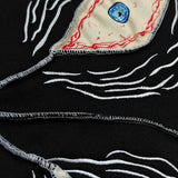Sudadera gótica oscura con diseño de mal de ojo y hip-hop.