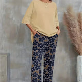 Conjunto elegante de top asimétrico y pantalón ancho con estampado floral para mujer