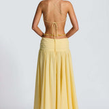 Vestido largo sin espalda con abertura, escote en V profundo, cuello halter y lazo.
