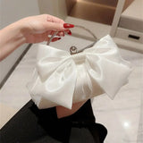Elegante bolso de noche en seda dorada con lazo, para llevar sobre el hombro.
