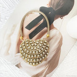 Bolso de mano en forma de corazón adornado con diamantes brillantes.
