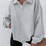 Sudadera holgada con mangas farol y cuello polo.