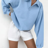 Sudadera holgada con mangas farol y cuello polo.