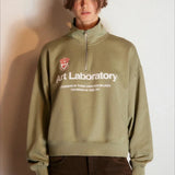 Sudadera oversize con media cremallera y cuello alto estampada con letras