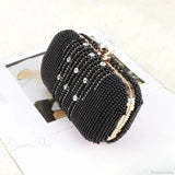 Pulsera de noche de lujo adornada con diamantes y perlas.