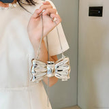 Mini bolso bandolera de metal con pajarita para noche o boda