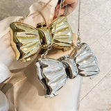 Mini bolso bandolera de metal con pajarita para noche o boda