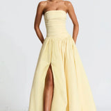 Elegante vestido largo con abertura y diseño de hombros descubiertos.