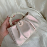Clutch de noche con asa de cuentas