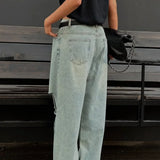 Vaqueros retro descoloridos con piernas anchas y rectas, hasta el suelo.