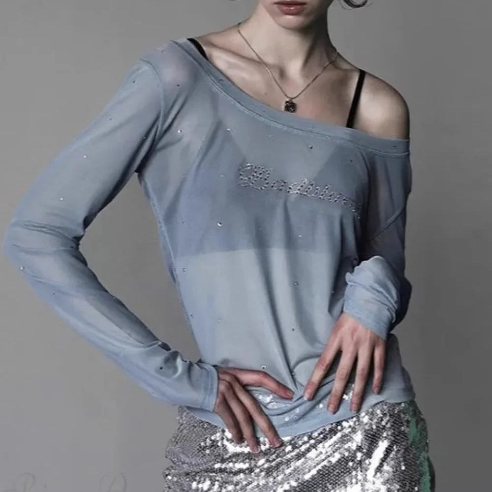Blusa sexy de tul adornada con pedrería y con diseño de hombros descubiertos.