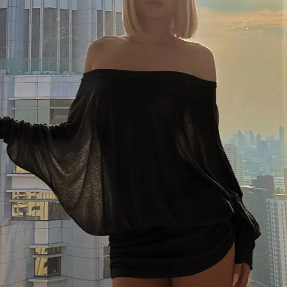 Blusa sexy lisa con mangas de murciélago y diseño de hombros descubiertos.