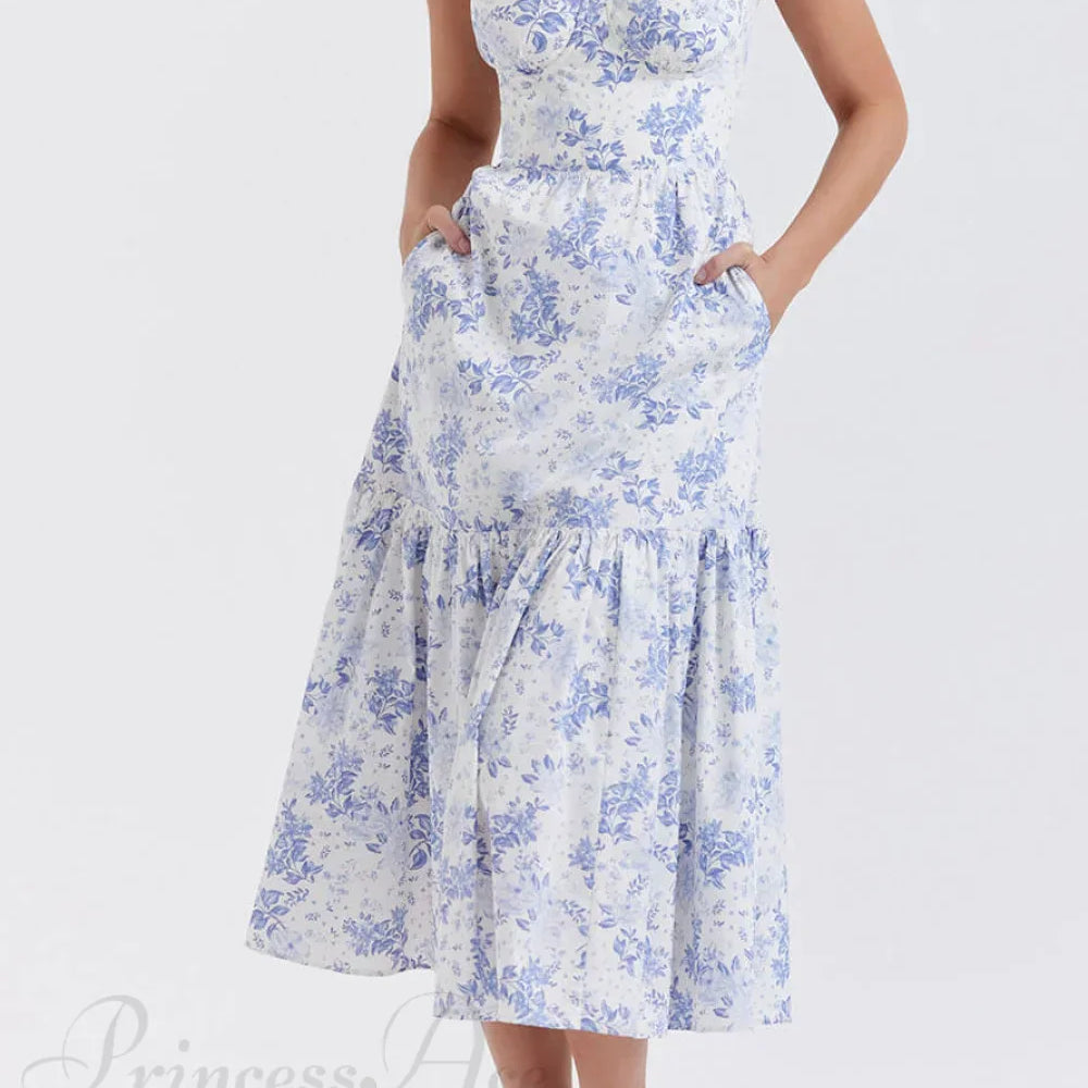 Elegante vestido midi floral con tirantes y bajo asimétrico.
