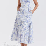 Elegante vestido midi floral con tirantes y bajo asimétrico.