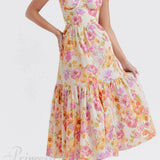 Elegante vestido midi floral con tirantes y bajo asimétrico.