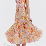 Elegante vestido midi floral con tirantes y bajo asimétrico.