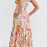 Elegante vestido midi floral con tirantes y bajo asimétrico.