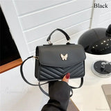Elegante bolso de mano en piel sintética bordado con mariposas.