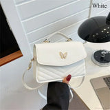 Elegante bolso de mano en piel sintética bordado con mariposas.