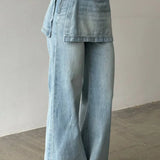 Vaqueros de tiro alto, asimétricos y de pierna ancha en denim lavado