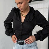 Blusa blanca de algodón con cuello abullonado y mangas abullonadas