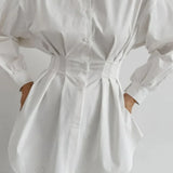 Blusa blanca plisada con cintura ajustada